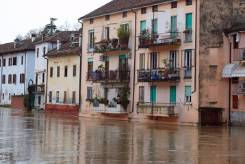 Floodwaters surge past houses threatening to overflow