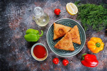 Fried samosas with vegetable filling, popular Indian snacks.