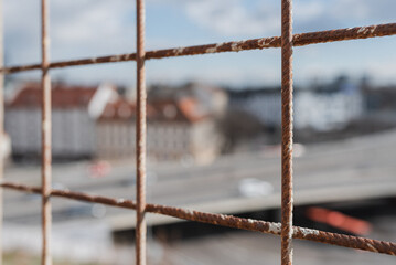 Rusty fence in view of town