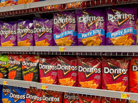 PORT CHARLOTTE, FLORIDA - APRIL 11, 2024 : Doritos corn snack chip selection at grocery store supermarket. Variety of salty junk food  snack flavors on store shelf.