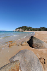 Arthur Bay beach scene with granite boulders in foreground, Magnetic Island, QLD, Australia