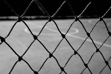 wire fence around basketball court - Powered by Adobe