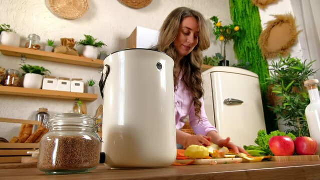 Woman recycling organic waste by composting vegetables peels in the Bokashi in the kitchen