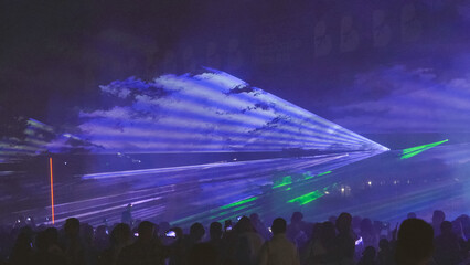 Laser show over the crowd at the party