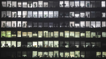 Night business building offices with employees working late