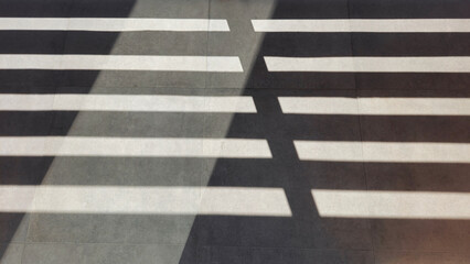 Shadow of wooden fence on floor in the one day afternoon. straight lines.