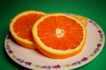 A sliced orange on the table. Fruits and vitamins.