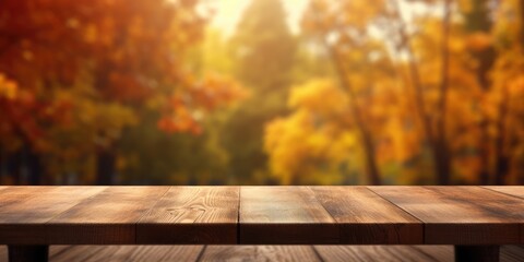 The empty rustic wooden table for product display with blur background of autumn forest. Exuberant...
