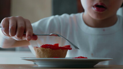Child Struggling to Reach Cheesecake with Fork - Close-Up View of Sugary Treat Topped with...