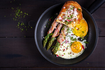 Keto breakfast. Fried eggs  with asparagus in bacon and toast. Top view, flat lay - 782317775