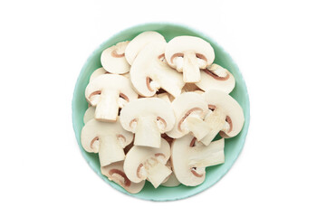 Fresh white champignon mushrooms on mint plate isolated on white background.