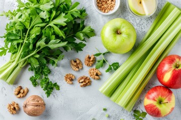 Ingredients for a Waldorf salad with celery apples and walnuts on a light surface