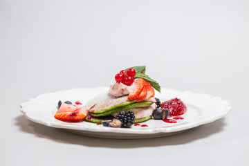 Fresh and Healthy Breakfast with Pancakes, Fruits, and Berries on White Plate