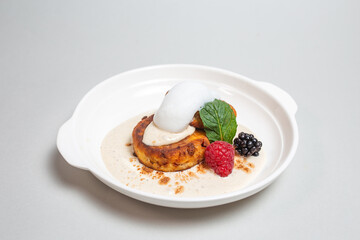 Delicious cottage cheese pancakes with raspberries and blackberries on a white background. Breakfast