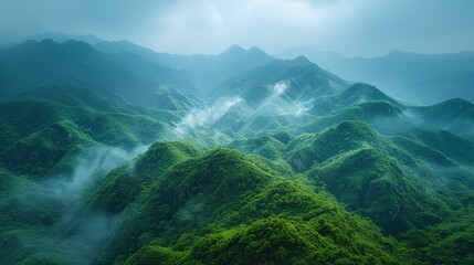  Mountains cloaked in green vegetation, mist rising from peak tops - obrazy, fototapety, plakaty