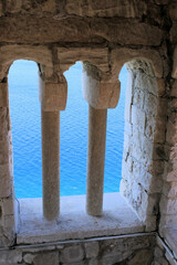 Fototapeta premium view on the blue sea, taken from inside a belltower, old town Rab, island Rab, Croatia