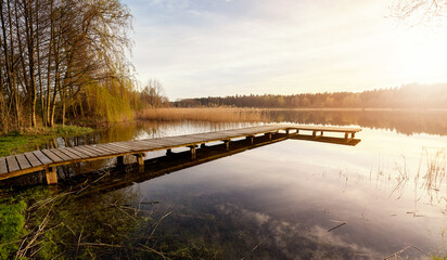 Scenic sunset with a pier on a lake near the town of Recz, West Pomeranian Voivodeship, Poland. - 782339733