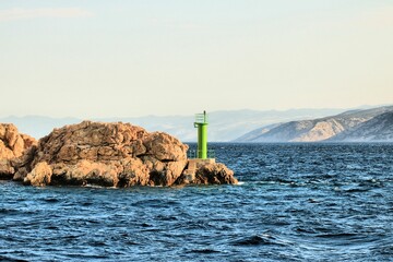 green lighthouse by arriving the island Rab by ferry, Croatia
