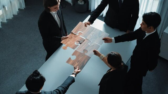 Top view of skilled businesspeople hand bring and fill the last jigsaw piece together. Group of project manager complete puzzle or solving problem. Unity, teamwork, successful project. Directorate.