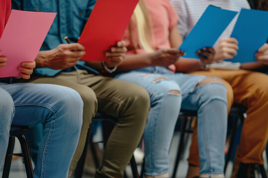 Group of people holding colorful folders at an event