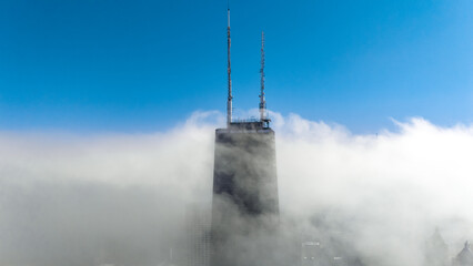 John Hancock building in Chicago surrounded by clouds, photo taken from Drone