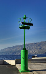 Simple metal small green lighthouse in the Island of Pag in Croatia