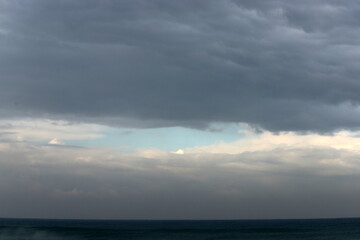 Rain clouds in the sky over the Mediterranean Sea.