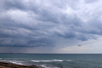 Rain clouds in the sky over the Mediterranean Sea.