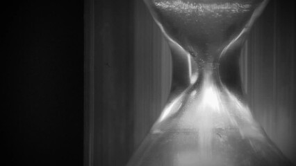 Time flows backwards, in opposite direction. Sand in hourglass. Time cures all things. Time is great healer. 4K Slow Motion time reversed video in retro style, old filming