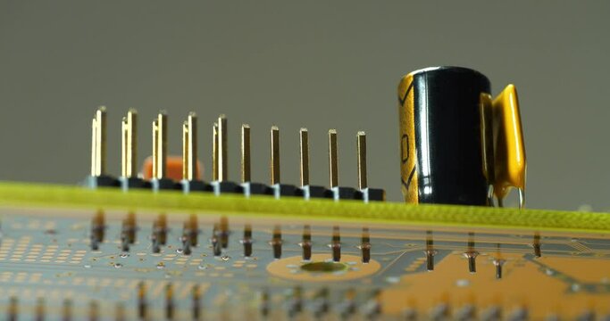 Computer microcircuit with electronic components, resistors and connection terminals. Cinema 4K 60fps zoom-in video