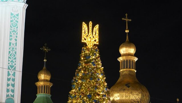 Christmas tree with coat of arms of Ukraine near Saint Sophia Cathedral or Sophia of Kiev, ancient historical monument of Kievan Rus. Today it is one of city best known landmarks