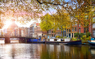 Amsterdam, Netherlands. Panoramic view of autumn Dutch city. Famous channel Amstel river. Evening cityscape. Colorful sunset scene famous travel destination in Europe. Romantic traveling place - 782396362