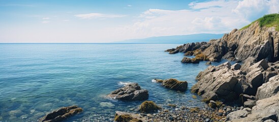 Grassy hill overlooking rocky shoreline