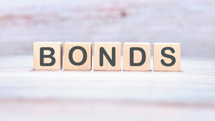 Bond indices on wooden cubes on an abstract background