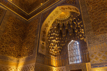 Inside the Gur-e-Amir mausoleum, deep niche and diverse muqarnas decoration