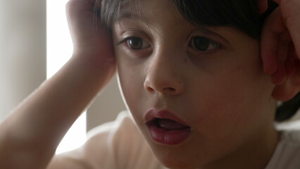 Lazy Drowsy Youngster in Deep Thought, Close-Up of Bored Little Boy Pondering. Close-up face of...