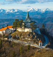 Pilgrimage site Sveta gora in Zasavje with Kamnik-Savinja Alps in the background, Slovenia