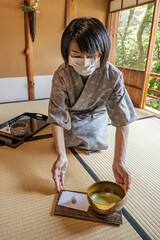 Japanese Green Tea Ceremony.
Woman serving traditional Japanese Matcha bowl.
