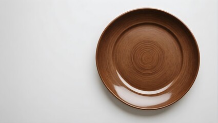 Empty brown circle ceramics plate isolated on white background with clipping path.