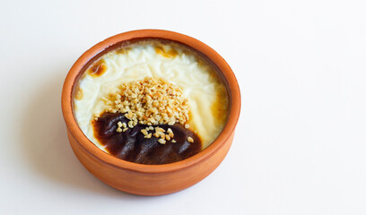 Traditional Turkish Style Baked Rice Pudding in casserole bowl,on white surface with copy space