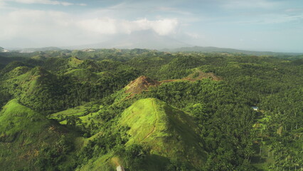 Aerial Philippines hill landscape: nobody wild nature with green tropic forest, abudant plant, high grass, lush mosses. Beautiful asian landmark natural wonder cinematic shooting in drone shot