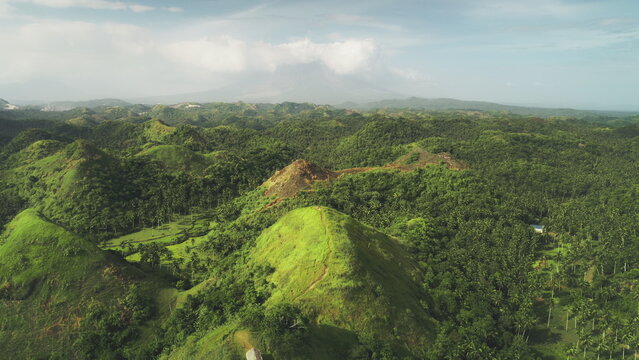 Aerial Philippines hill landscape: nobody wild nature with green tropic forest, abudant plant, high grass, lush mosses. Beautiful asian landmark natural wonder cinematic shooting in drone shot