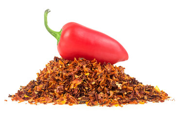 Red jalapeno pepper and pile of dried chili pepper flakes isolated on a white background