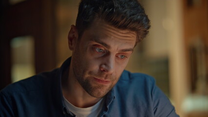 Worried freelancer talking online late at home closeup. Nervous man video call