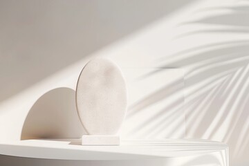 A stone art piece on a minimalist white display, casting soft shadows in sunlight. Abstract Minimalist Stone Display Art