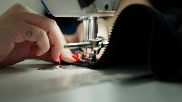 Attentive Sewing of Zipper onto Fabric. Detailed work of attaching zipper to material. Concept Precision in Sewing