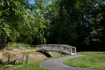 Tranquil Park Bridge Over a Small Creek, Paved Walking Bath
