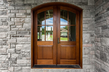 Elegant Wooden Front Double Door on Stone Wall Façade, New Construction