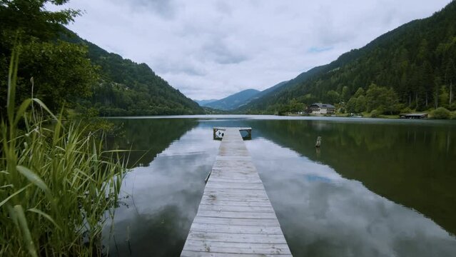 steadycam shot of serene mountain alpine lake surrounded by forest a peaceful trave 4K  