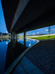 Serene Evening Under The Bridge In Gothenburg, Sweden With Calm Waters Reflecting The Lights